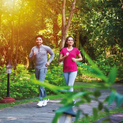 Couple jogging on a landscaped track, representative of The Trilight Kokapet